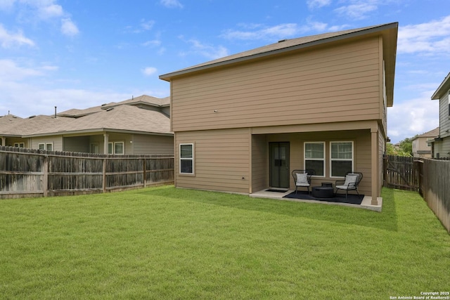 rear view of property featuring a patio and a lawn