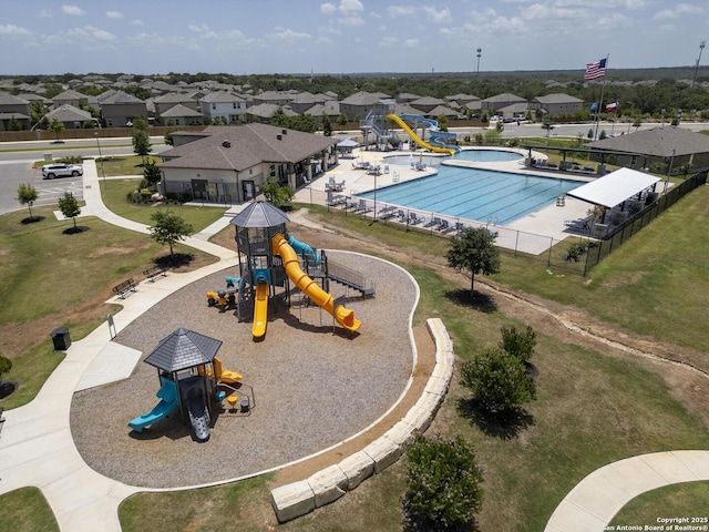 view of swimming pool featuring a playground