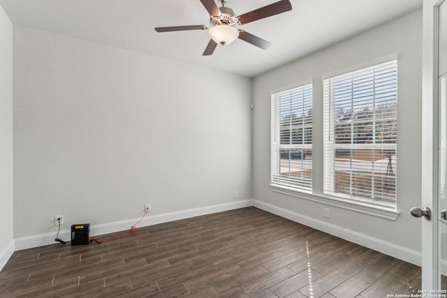 spare room with dark hardwood / wood-style flooring and ceiling fan