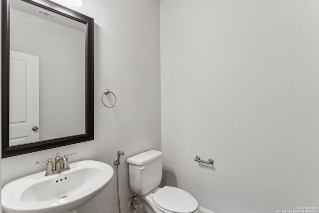 bathroom featuring sink and toilet