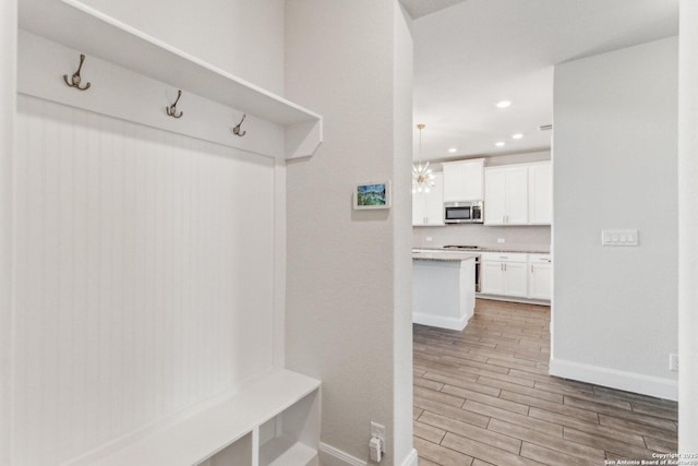 mudroom with an inviting chandelier