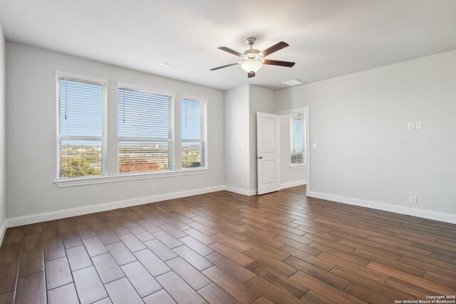 spare room featuring dark hardwood / wood-style flooring and ceiling fan