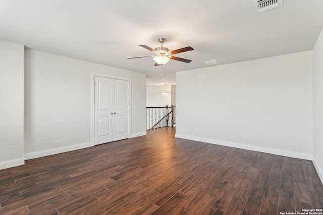 empty room featuring dark wood-type flooring and ceiling fan