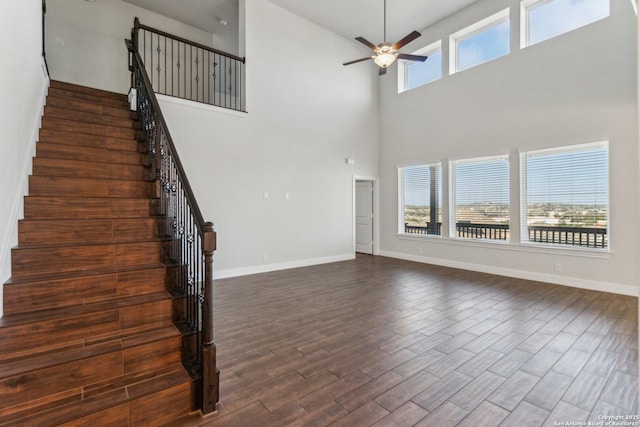 unfurnished living room with dark wood-type flooring and ceiling fan