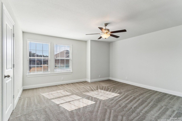 spare room featuring light carpet, a textured ceiling, and ceiling fan