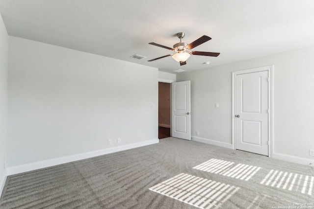 unfurnished room with light colored carpet and ceiling fan