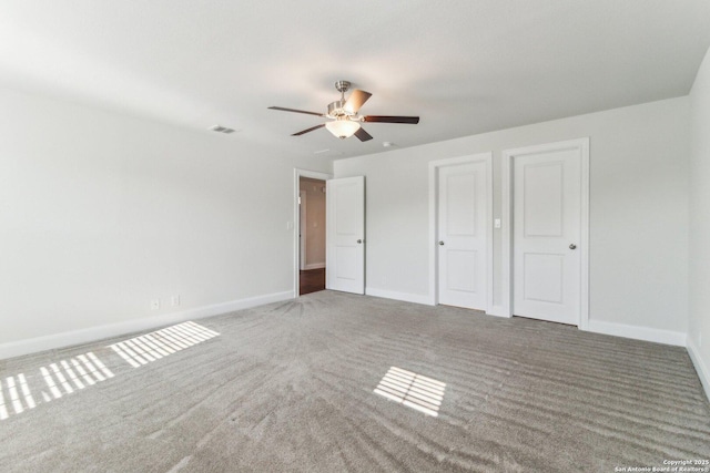 unfurnished bedroom with ceiling fan and carpet flooring