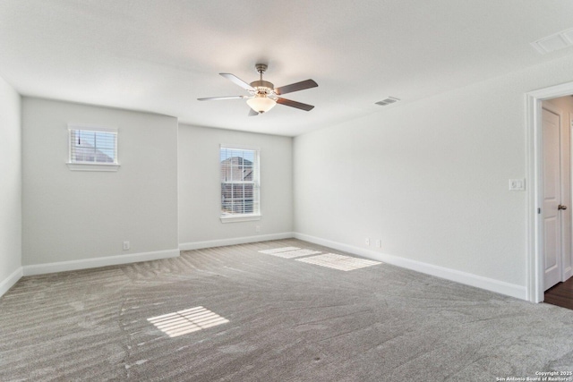 carpeted spare room featuring ceiling fan