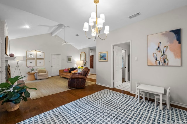 living room with lofted ceiling with beams, wood-type flooring, ceiling fan with notable chandelier, and a fireplace