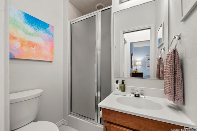 bathroom featuring an enclosed shower, vanity, and toilet