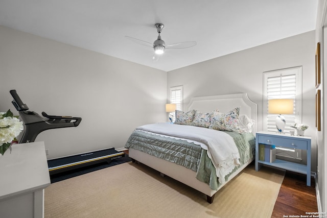 bedroom with ceiling fan and hardwood / wood-style floors