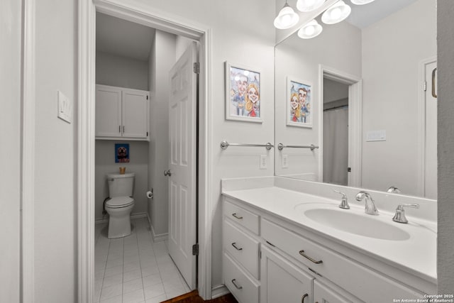 bathroom featuring tile patterned floors, vanity, and toilet