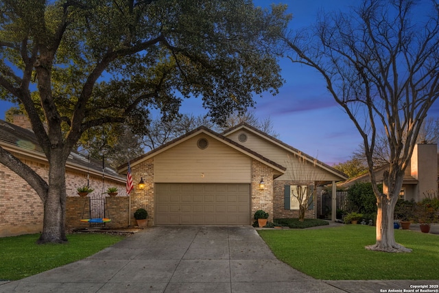 ranch-style home with a garage and a yard