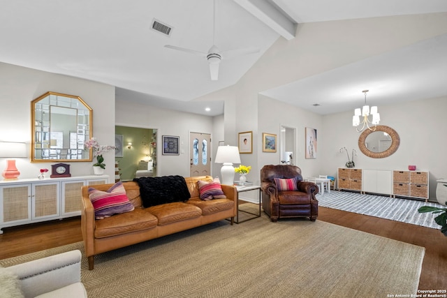 living room with hardwood / wood-style floors, ceiling fan with notable chandelier, and lofted ceiling with beams