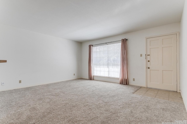 spare room featuring light colored carpet