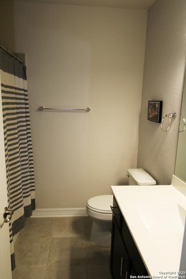 bathroom featuring a shower with shower curtain, vanity, toilet, and tile patterned flooring