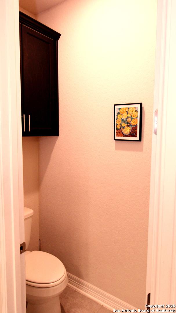 bathroom featuring tile patterned floors and toilet