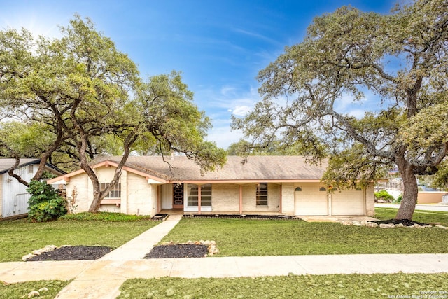 ranch-style house with a garage and a front lawn