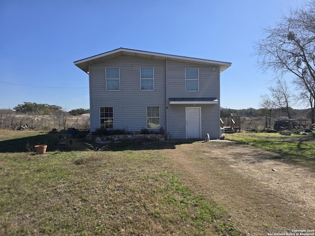 back of house featuring a yard