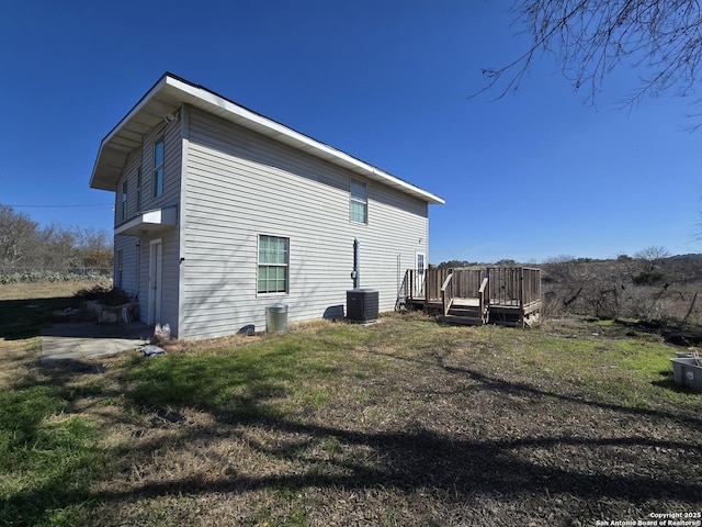 view of home's exterior featuring a wooden deck and central air condition unit