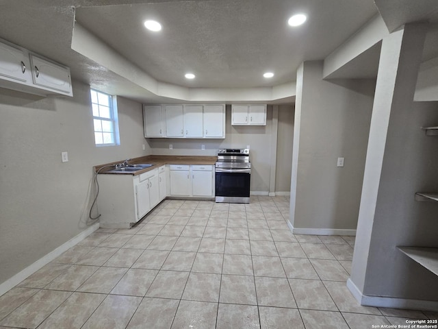 kitchen with light tile patterned flooring, sink, a textured ceiling, stainless steel electric range, and white cabinets