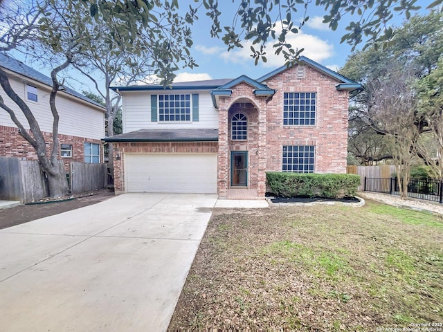 view of property featuring a garage and a front yard