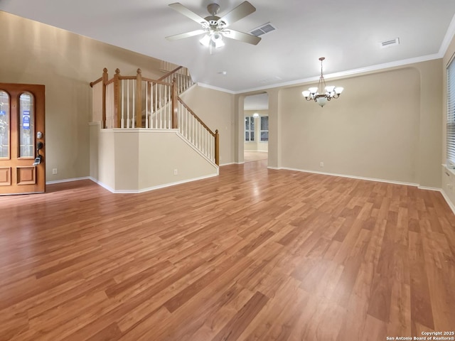 unfurnished living room with ceiling fan with notable chandelier, ornamental molding, and light hardwood / wood-style floors