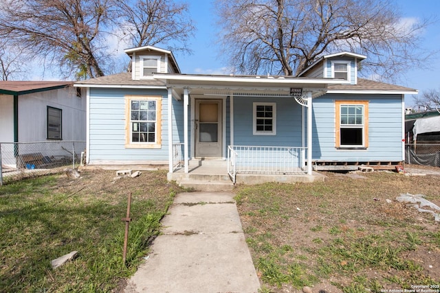 bungalow-style home featuring a front lawn and a porch