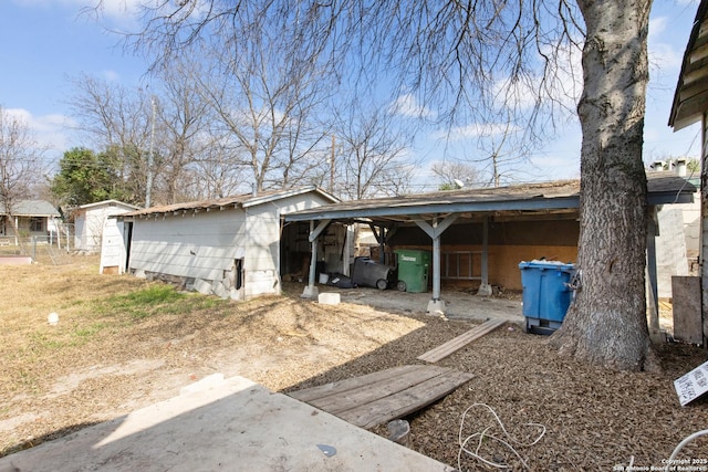 view of home's exterior with an outbuilding