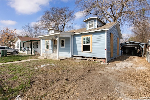 view of front of house with a porch and a carport