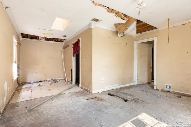 spare room featuring a skylight