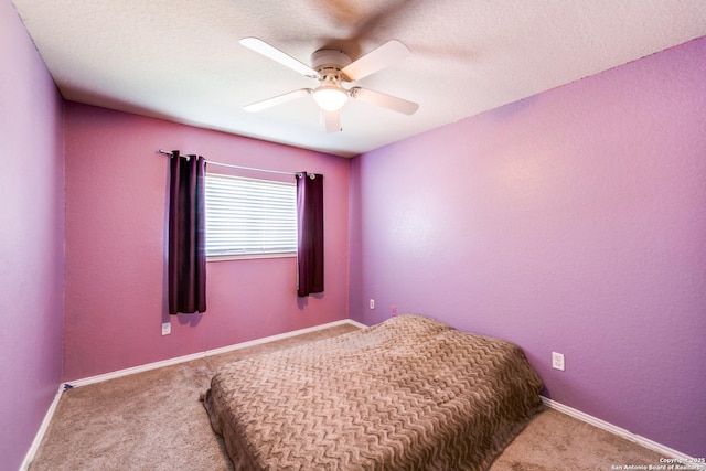 bedroom featuring carpet floors, a textured ceiling, and ceiling fan