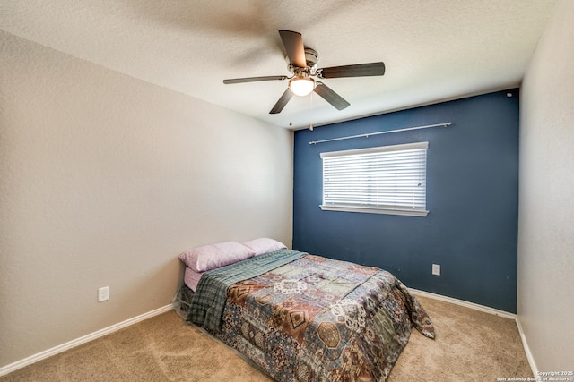 bedroom featuring carpet, a textured ceiling, and ceiling fan