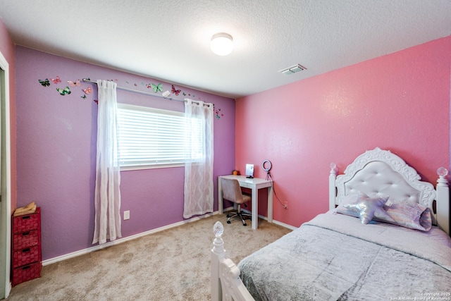 bedroom with light colored carpet and a textured ceiling