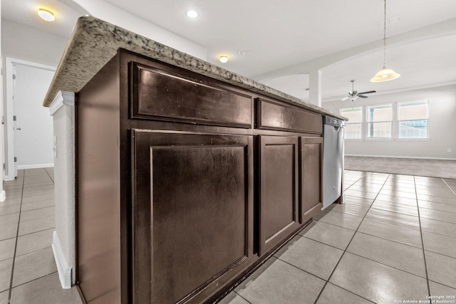 interior space with light tile patterned flooring, ceiling fan, decorative light fixtures, and dark brown cabinets