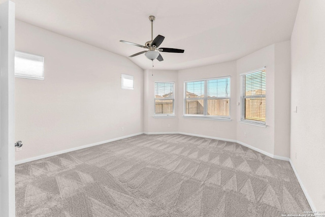 unfurnished room with light carpet, vaulted ceiling, and ceiling fan