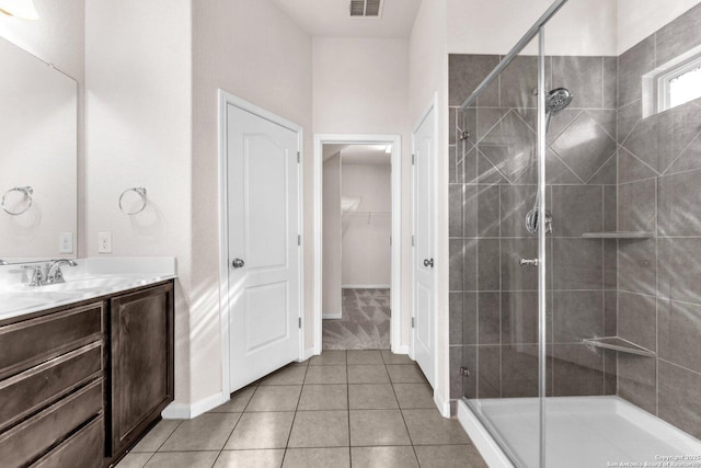 bathroom with vanity, tile patterned flooring, and walk in shower