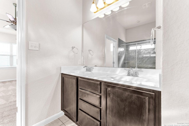 bathroom featuring tile patterned flooring, vanity, and walk in shower