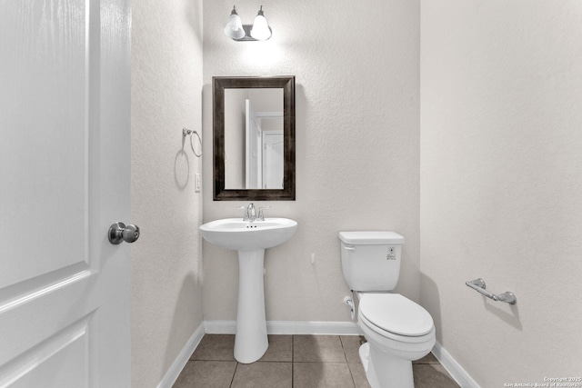 bathroom featuring tile patterned flooring, sink, and toilet