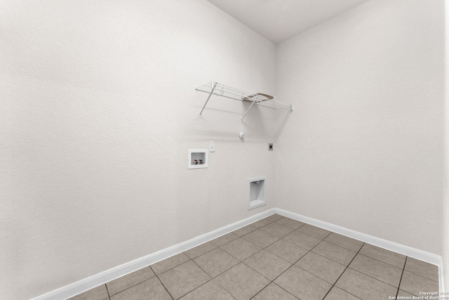 washroom featuring hookup for a washing machine, gas dryer hookup, electric dryer hookup, and light tile patterned floors