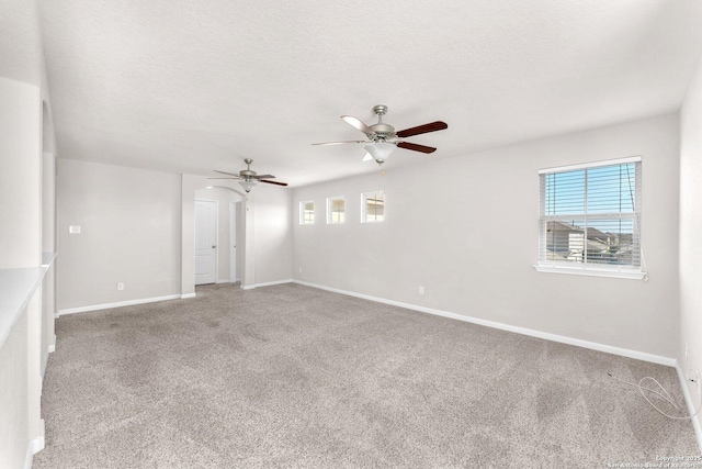 spare room featuring ceiling fan, carpet flooring, and a textured ceiling