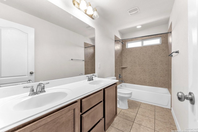 full bathroom with vanity, toilet, tiled shower / bath combo, and tile patterned flooring