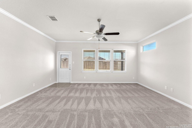 carpeted spare room featuring crown molding and ceiling fan