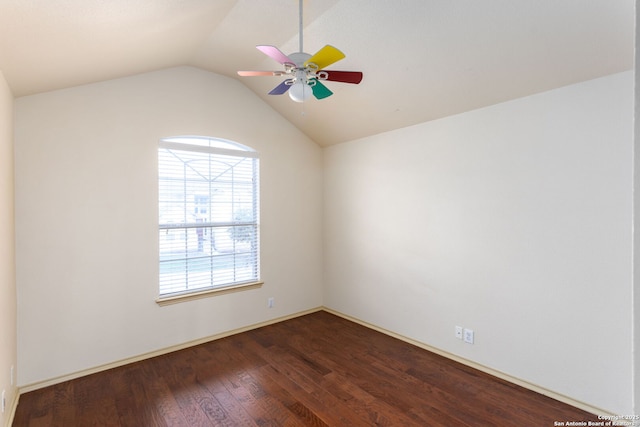 spare room featuring dark wood-type flooring, ceiling fan, and vaulted ceiling