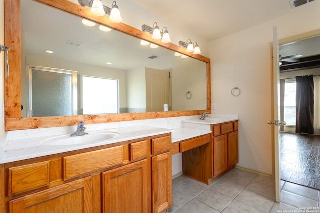 bathroom featuring tile patterned flooring, vanity, and walk in shower