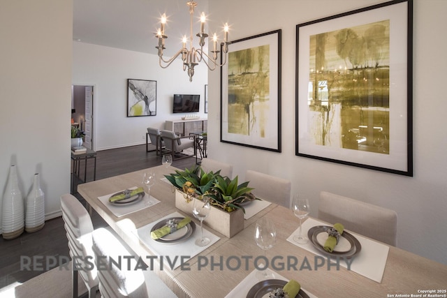 dining room with dark hardwood / wood-style floors and a chandelier