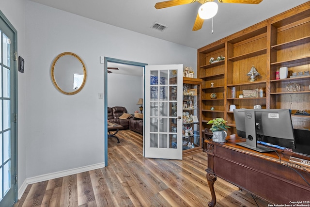 office with hardwood / wood-style flooring, ceiling fan, and french doors