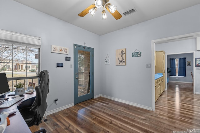 home office with ceiling fan and dark hardwood / wood-style flooring