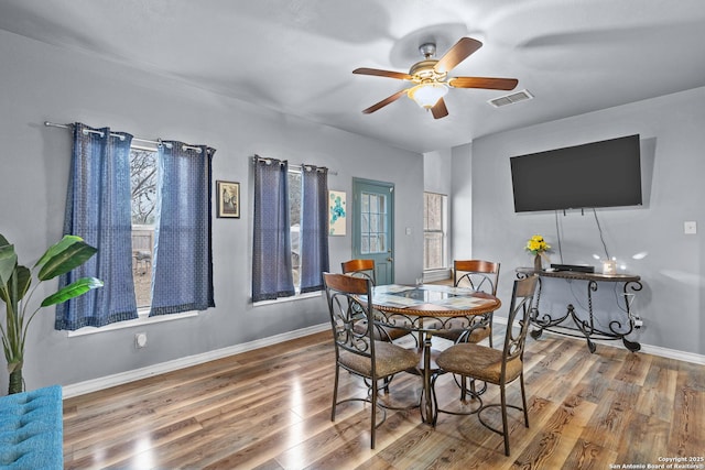 dining room with wood-type flooring and ceiling fan