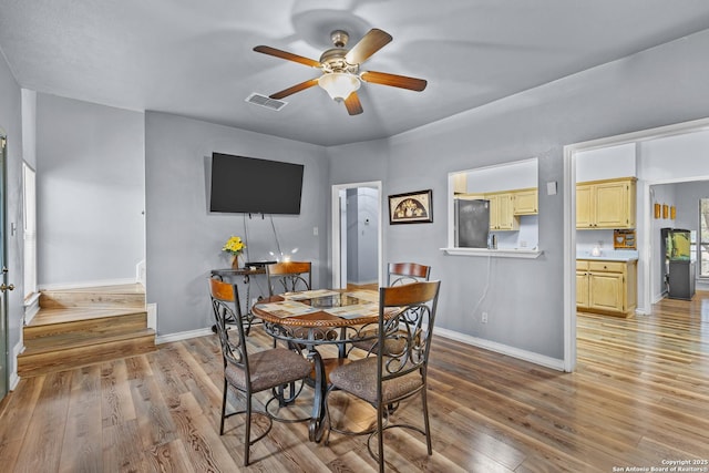 dining area featuring ceiling fan and light wood-type flooring